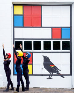 TaMaMa Dance Company performing in front of the Mondrian Garage Mural on Third Street in Marquette MI for Artweek.